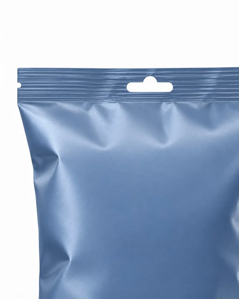 Top section of a back seal bag showing the easy-open zone with tear notch and hang hole near the top seal.