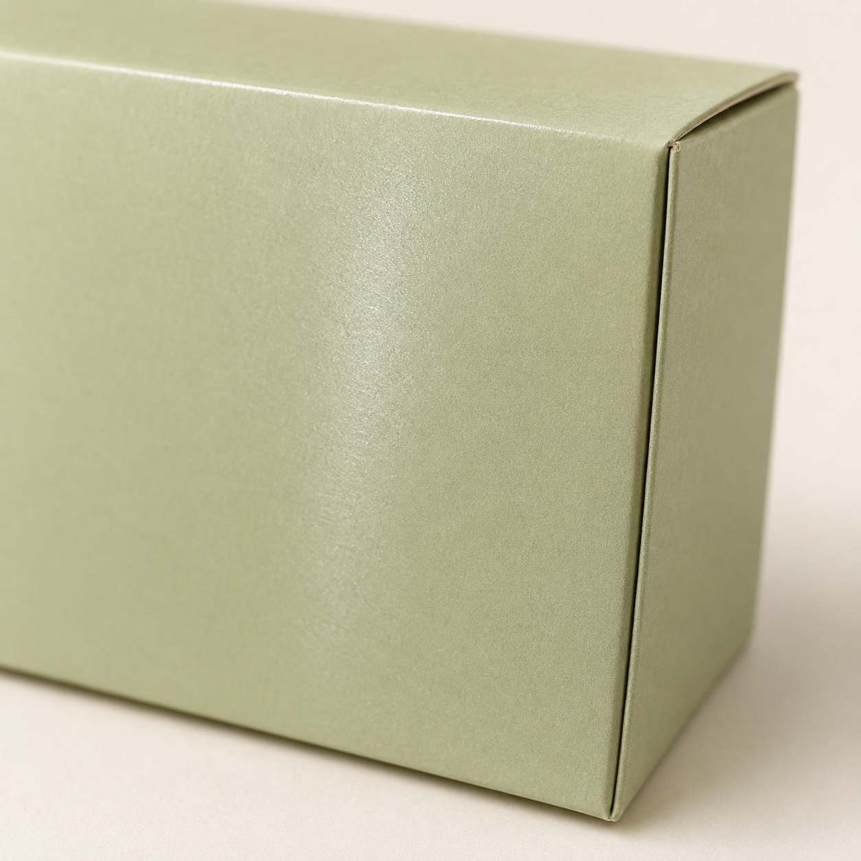 Sage paperboard box with a smooth, lightly coated satin surface.