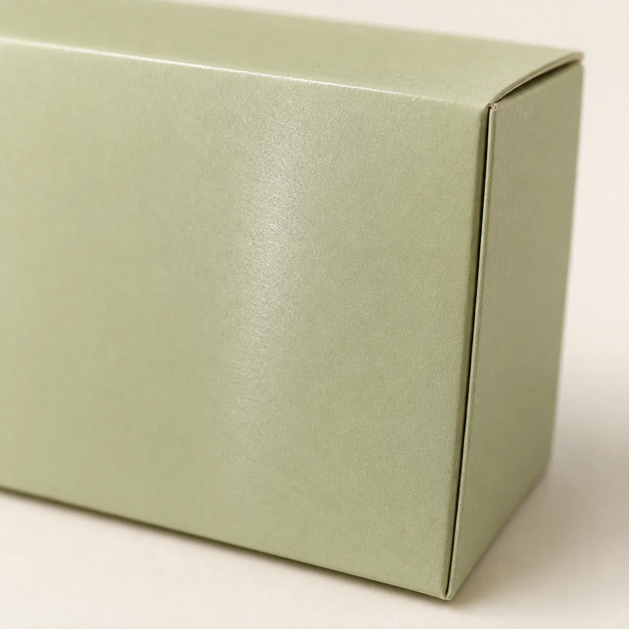 Sage paperboard box with a smooth, lightly coated satin surface.