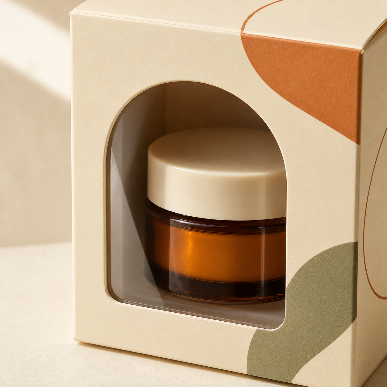 Packaging box with a clear film window displaying an amber cosmetic jar.