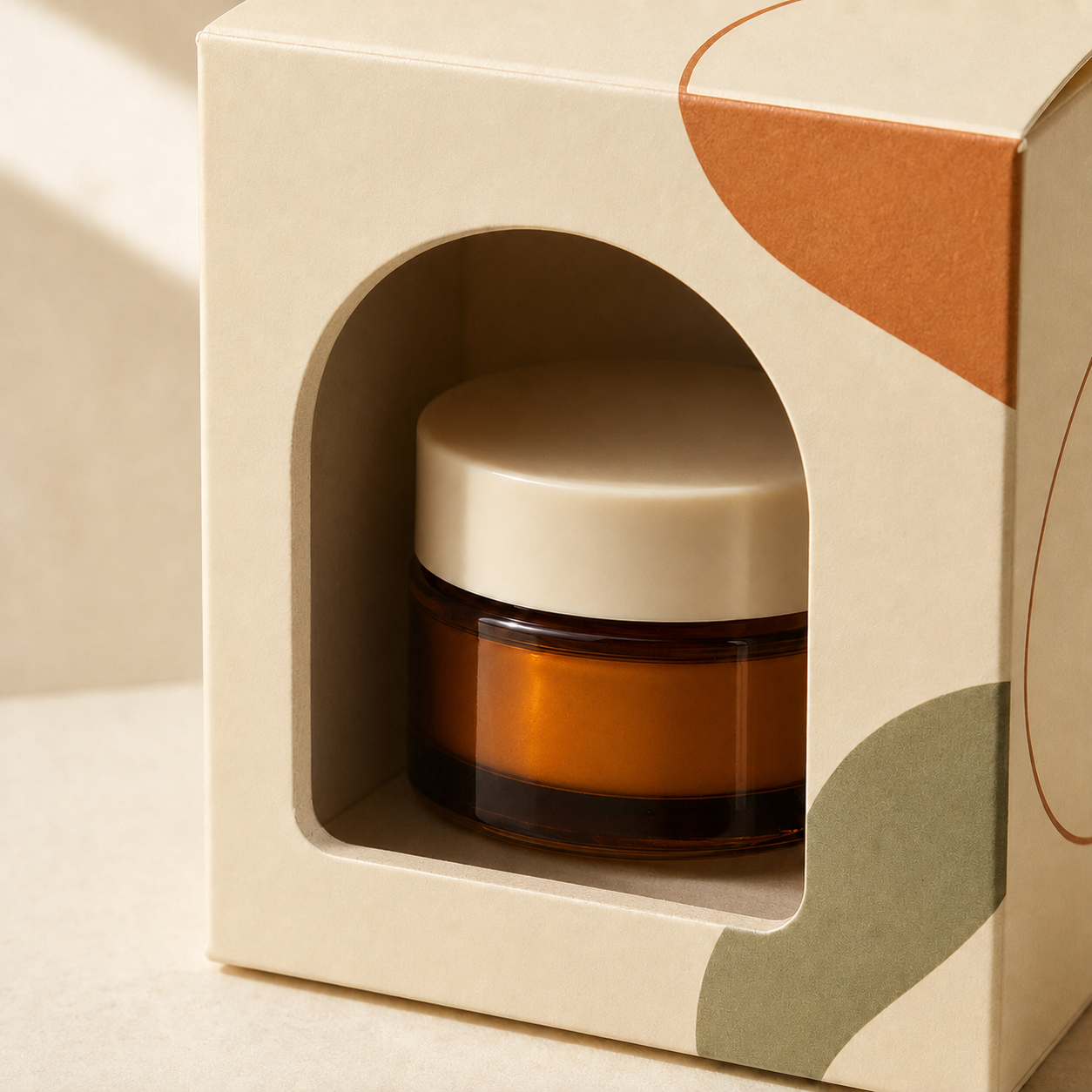 Packaging box with an open die-cut window revealing an amber cosmetic jar.