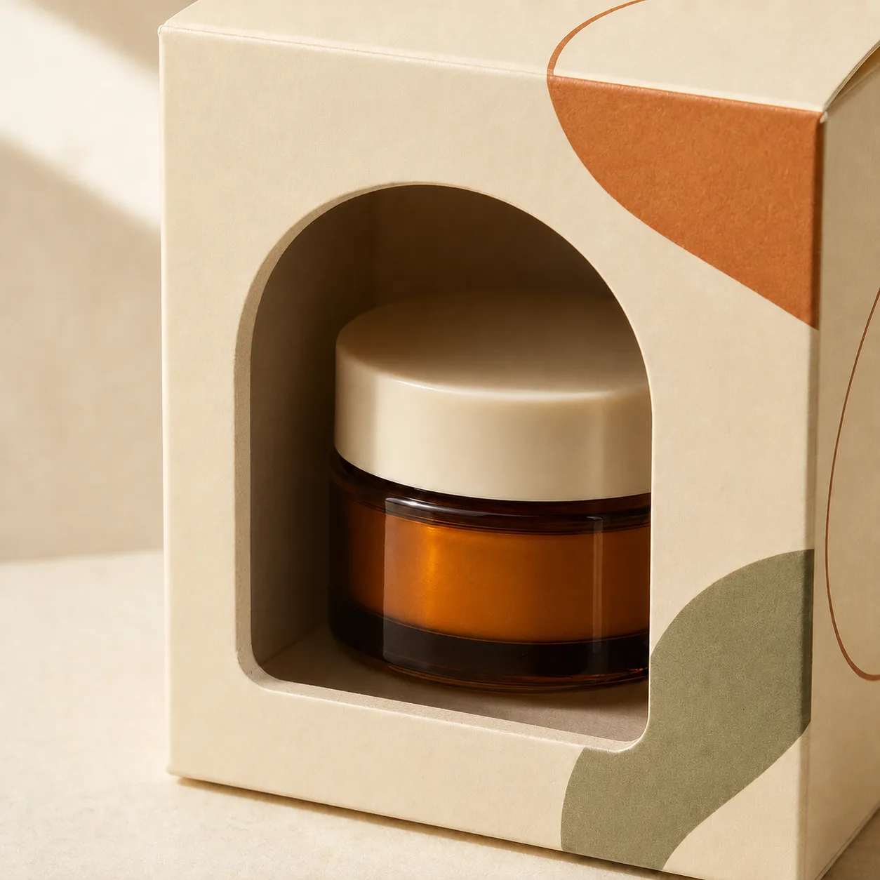 Packaging box with an open die-cut window revealing an amber cosmetic jar.