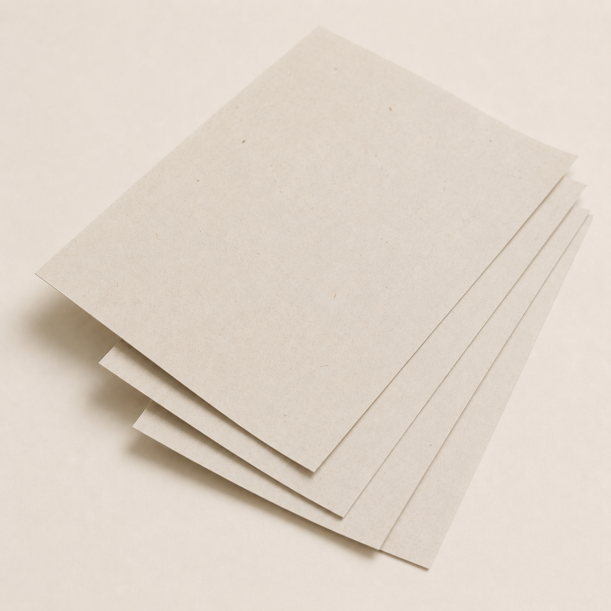 Thin recycled paperboard sheets with visible natural fiber flecks.