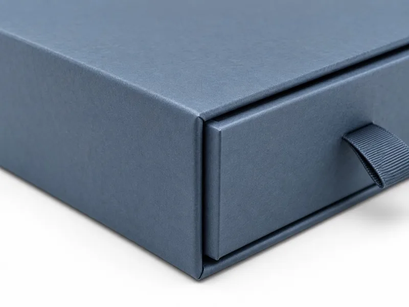 Close-up of a custom drawer box showing the wrap paper covering the rigid greyboard structure.
