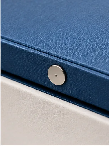 Close-up of a magnetic closure detail used to keep the lid closed on a hinged rigid box.