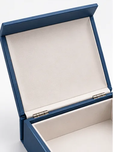 Inner lid of a hinged rigid box showing the surface that frames the product when the box is open.