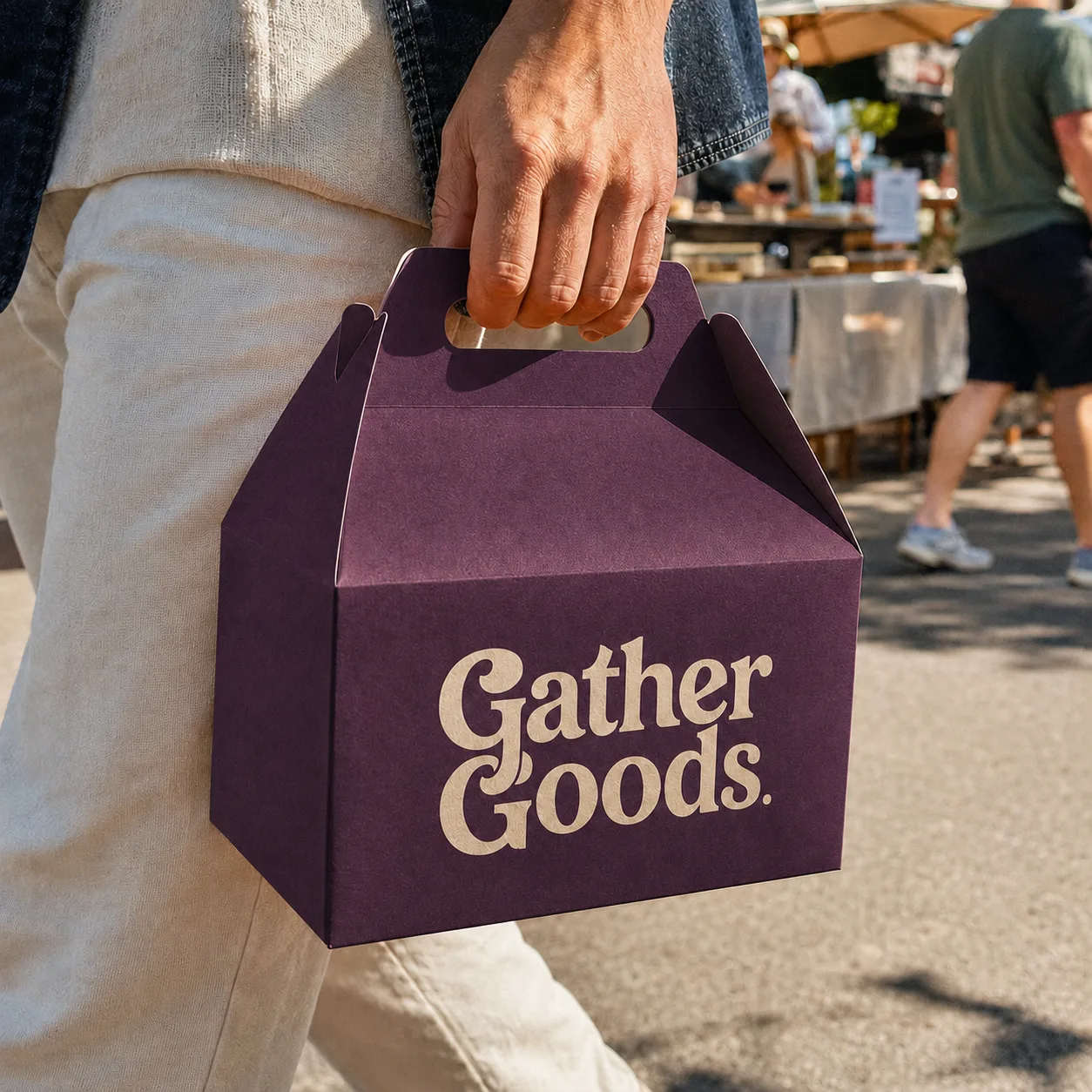 Gable box with handle carried by hand at an outdoor market