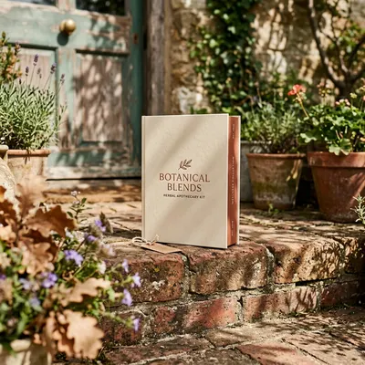 Book-style rigid box with foil-stamped cover and ribbon closure