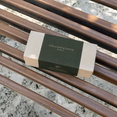Box sleeve wrapped around a rectangular bakery box, overhead view