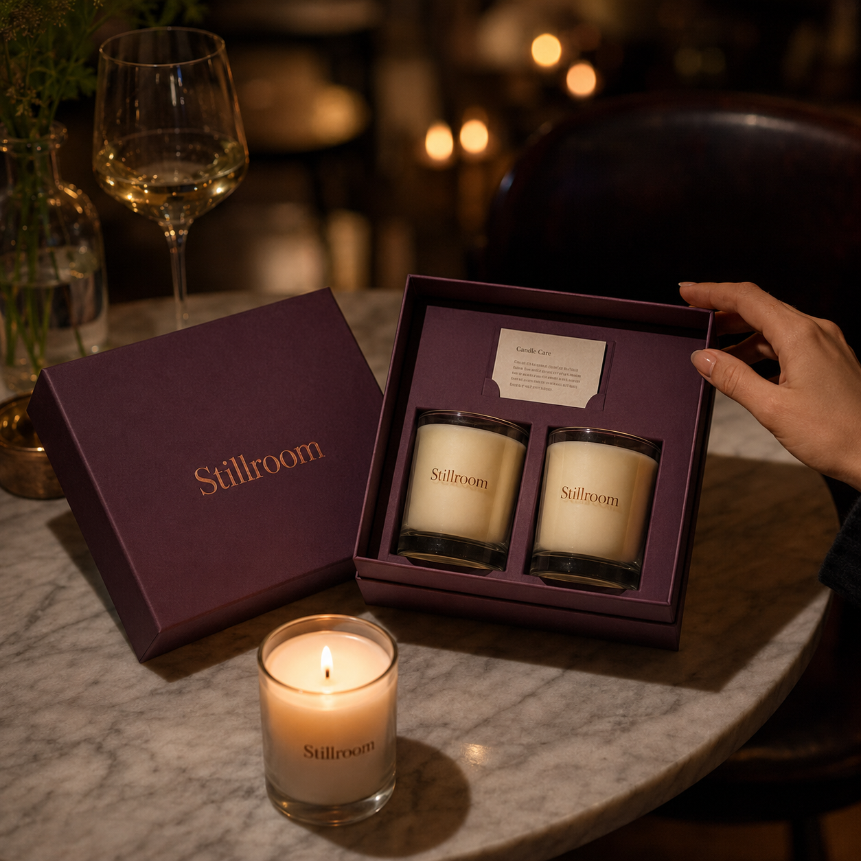 Candle gift box open to reveal two glass candles inside