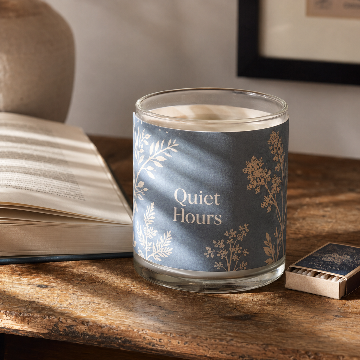 Candle packaging sleeve wrapped around a glass candle on a table
