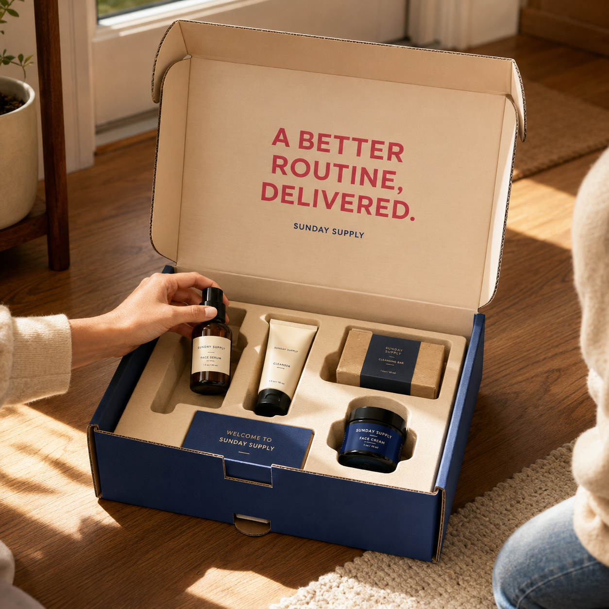 Open navy subscription box with skincare products in custom foam insert