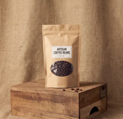 Kraft stand-up window mylar bag with oval die-cut opening showing coffee beans
