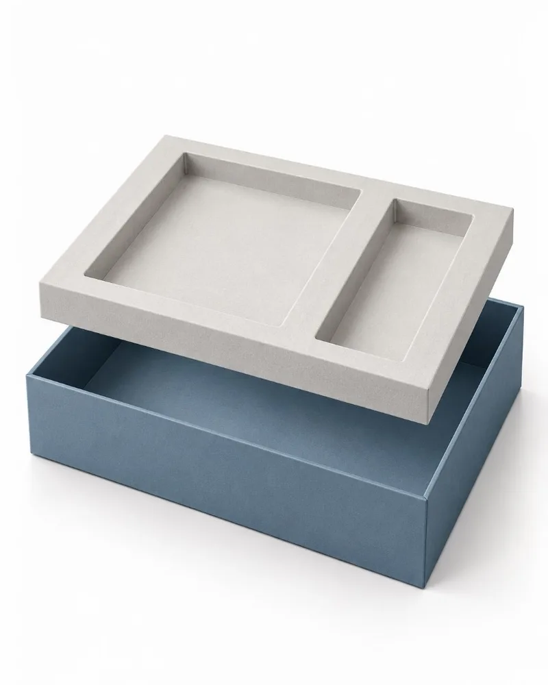 Two piece rigid box base with a fitted insert raised to show its shaped product compartments.